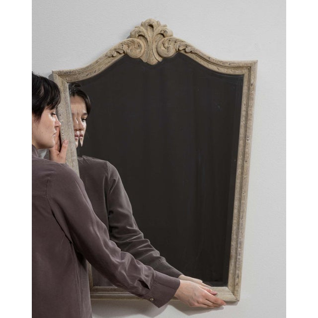 This mirror makes its impression through whitewashed carved crest frame, arched. The piece dates to 20th Century, sourced...