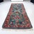 This is a mid-century hand knotted wool rug with a vibrant turquoise field with floral and botanical motifs. It has hand...