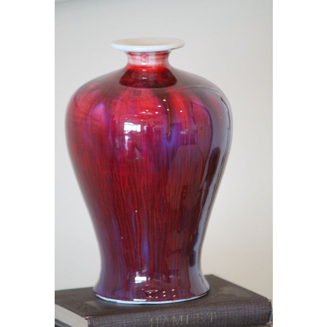 A stunning flambe vase, with amazing shades of burgundy and purple, with a primary oxblood color. Excellent, even glaze...