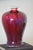 A stunning flambe vase, with amazing shades of burgundy and purple, with a primary oxblood color. Excellent, even glaze...