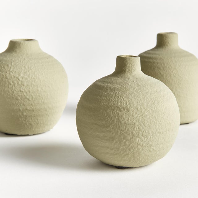 With a matte glaze, imperfect texture and basic form, these three soft green bud vases are simple and raw. Just like a...