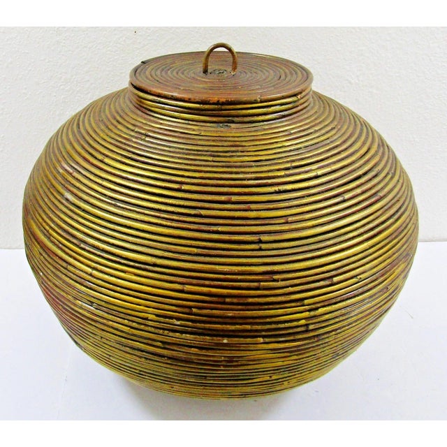 This Vintage 1970s Large Bamboo Pencil Reed Lidded Floor Basket by Gabriella Crespi is a handmade, round storage basket...
