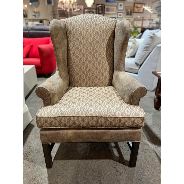 Classic elegance meets cozy comfort in the Heckman “Celeste” Wingback Chair. Upholstered in rich brown fabric, this chair...