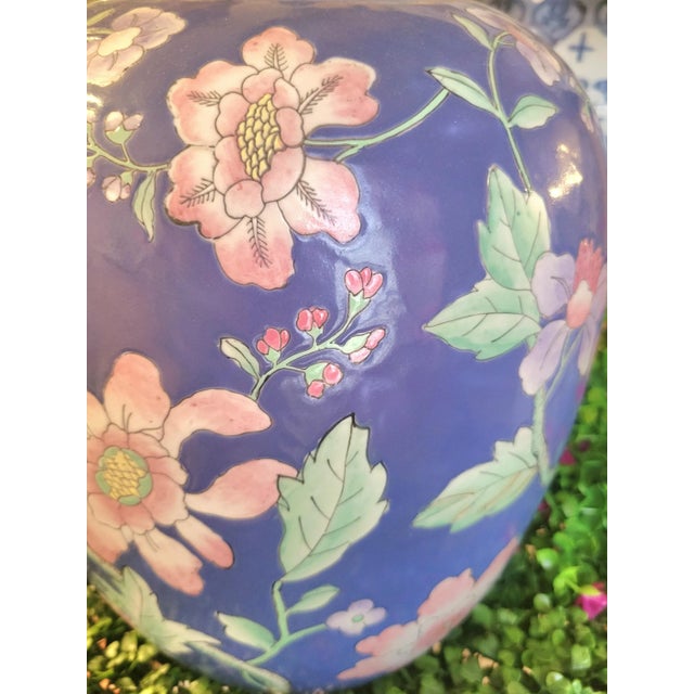A beautiful very large ceramic Japanese Chinoiserie blue, pink, green ginger jar. The jar has a beautiful bright blue...