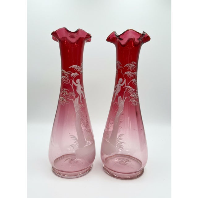 An exceptional and highly desirable facing pair of authentic late-Victorian Mary Gregory cranberry art glass vases, circa...