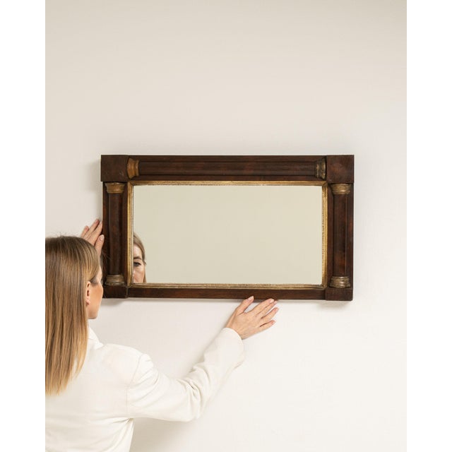 This mirror makes its impression through dark wood frame with gilt corner blocks. Originating in France during 19th...