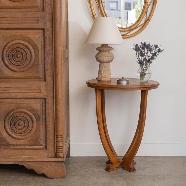 Incredible Art Deco side table from France, 1930s. Circular top rests on four carved wood slender curvy legs. Newly...
