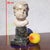 Beautiful white marble putto head mounted on a green marble column: this chubby putto is depicted in the purest Baroque...