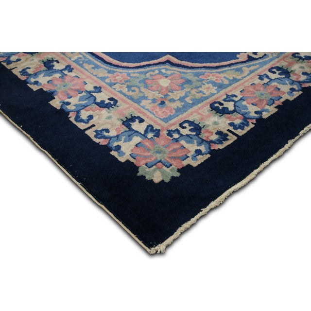 This semi-antique Chinese Art Deco rug, measuring 5' x 7'9", is handwoven with wool on a cotton foundation. Although the...