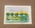 A luminous original watercolor landscape capturing a quiet meadow beneath a softly painted summer sky. A row of loosely...