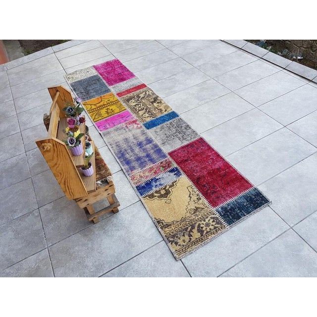 This is a vintage Turkish Oushak rug from the Mid 20th Century. The piece was hand-knotted.