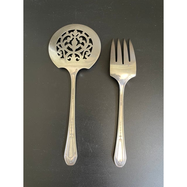 Lot of 2 serving pieces in the Hampton Court pattern by Community Plate (Oneida Silver), including a tomato server and a...