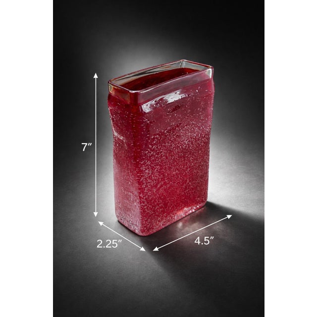 A striking vintage ruby art glass vase featuring a dense controlled bubble field suspended within thick cased glass. The...