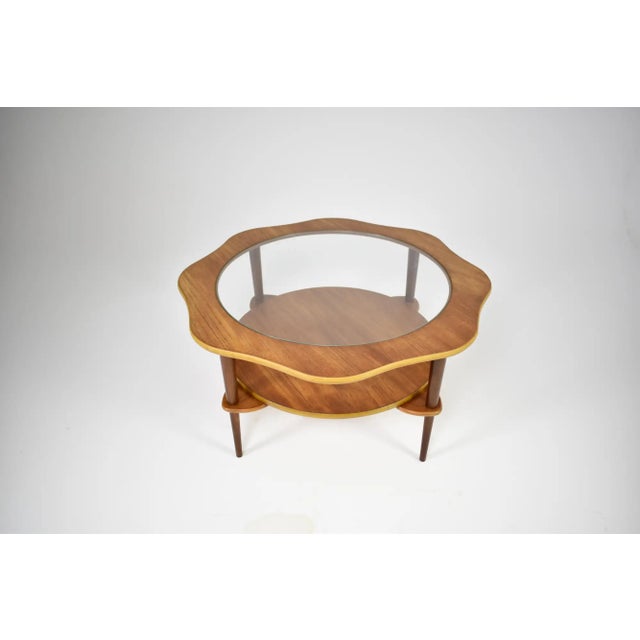 This sculptural circular cocktail table dating from the 1960s, is a definitive example of post-war organic modernism. It...