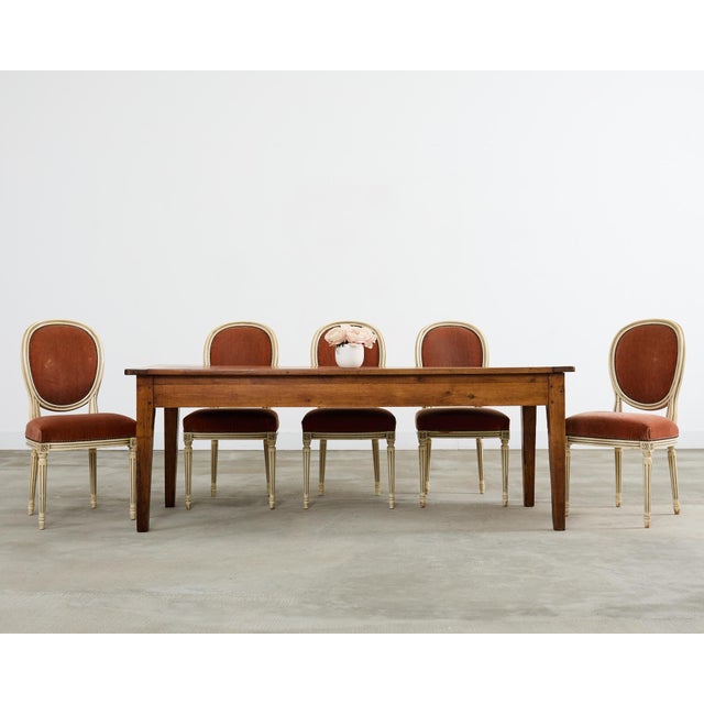 Exquisite set of six 20th century French dining chairs crafted in the Louis XVI taste. The chairs feature carved and...
