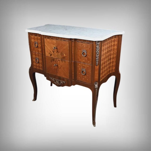 This superb Transition-style commode with a central projection elegantly embodies the refinement of fine furniture....