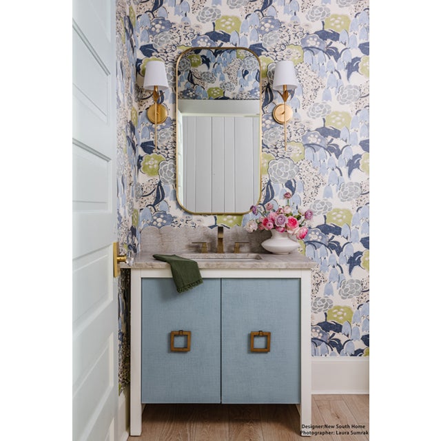 The April bath vanity exudes feminine grace with elegant, textured light blue linen doors and matte white lacquer case....