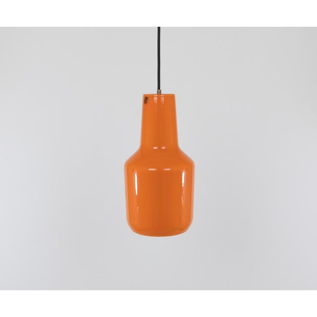 Hand-blown glass orange pendant designed by Massimo Vignelli at the start of his impressive career in design and produced...