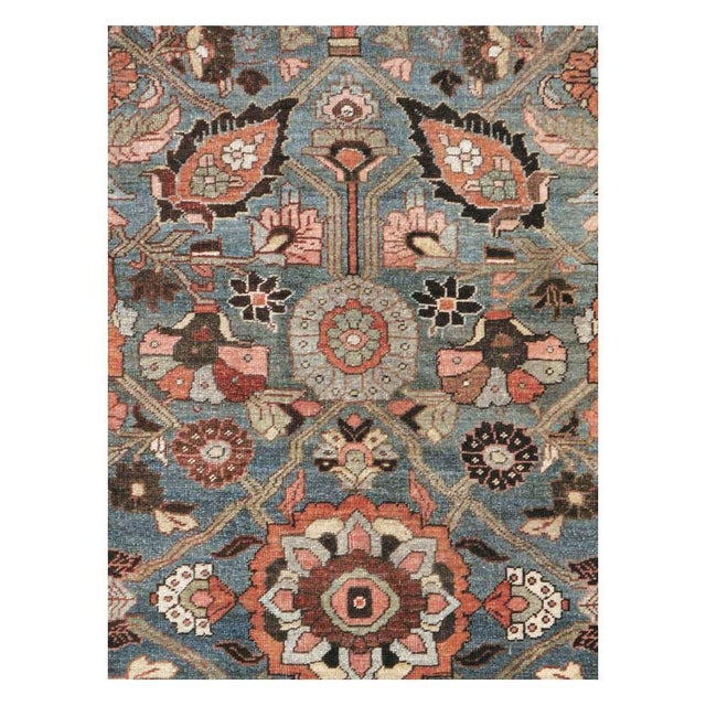 This early 20th-century Persian Bidjar small room-size carpet presents an intricate floral composition across a rich blue...