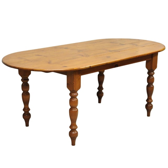 Vintage French Country Oval Distressed Pine Wood 78" Turn Carved Baluster Leg Farmhouse Dining Table. Circa Mid 20th...