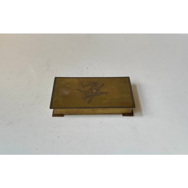 Decorative Bronze Malm box with a stylized center motif of Diana The Archer to its lid. Its wooden interior keeps your...