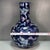 A striking large Chinese porcelain bottle vase featuring a deep, dark blue glazed ground. The vase is vividly decorated...