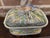 A majolica lidded game dish of earthenware decorated with a high gloss glaze and a three dimensional figural fish on a...