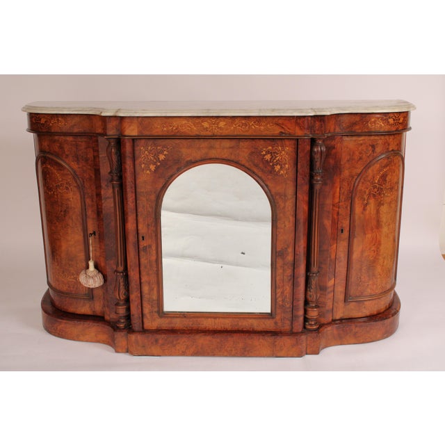 English Victorian inlaid burl walnut sideboard / server with marble top, circa 1880. With a Carrera marble top with molded...