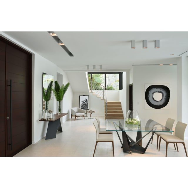 A striking Skorpio dining table by Cattelan Italia, known for its sculptural steel base and refined modern design. This...