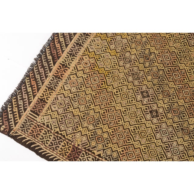 This is a vintage Turkish Oushak rug from the Mid 20th Century. The piece was hand-knotted.