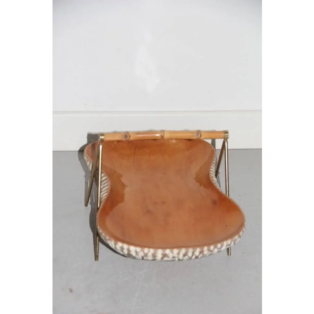 This elegant candy box or trinket bowl is made of carved wood with brass parts.