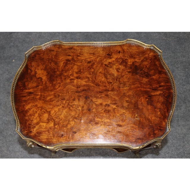 This elegant French Louis XV style bronze-mounted two-tier occasional table, dating from the late nineteenth century...