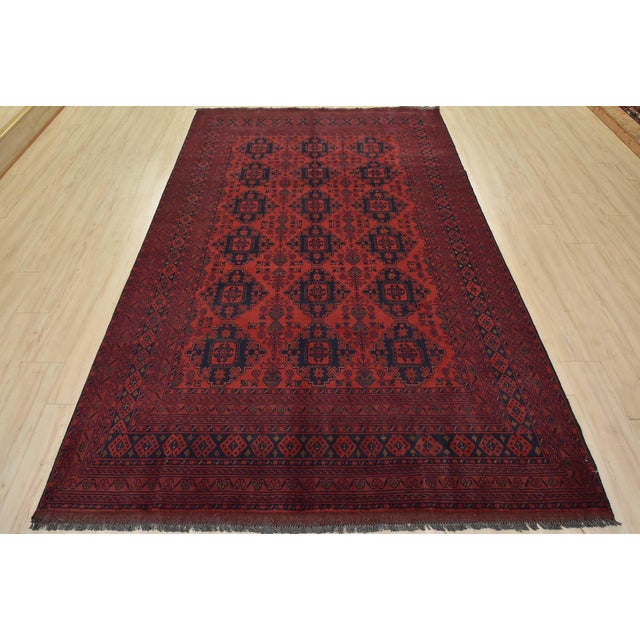 A tribal Turkmen rug hand-knotted with an all-wool pile on a wool foundation. This oriental rug features rows of geometric...
