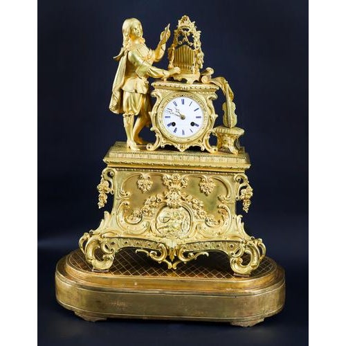 This is a lovely antique french rococo revival ormolu, (gilt bronze) mantel clock with glass dome and giltwood base by the...