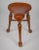 Rare and elegant mahogany three-legged stool with saddle-shaped seat, by James Shoolbred and Co., beautifully carved and...