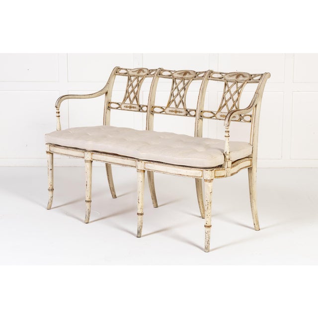 19th century english regency painted cane seat settee with original paint and decoration. this elegant settee embodies the...