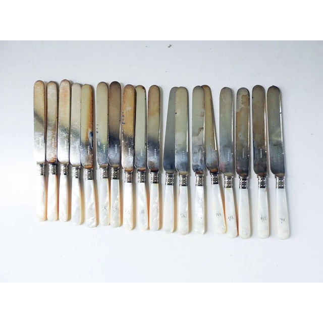 Set of 18 antique English silverplate and mother of pearl handled knives. Manufactured by Harrison Brothers & Howson,...