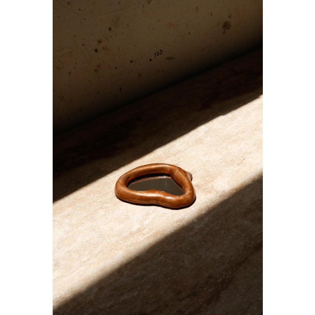 The Echoe Mini Mirror is a hand-sculpted, hand-cast, and hand-painted collectible design piece in resin and stone...