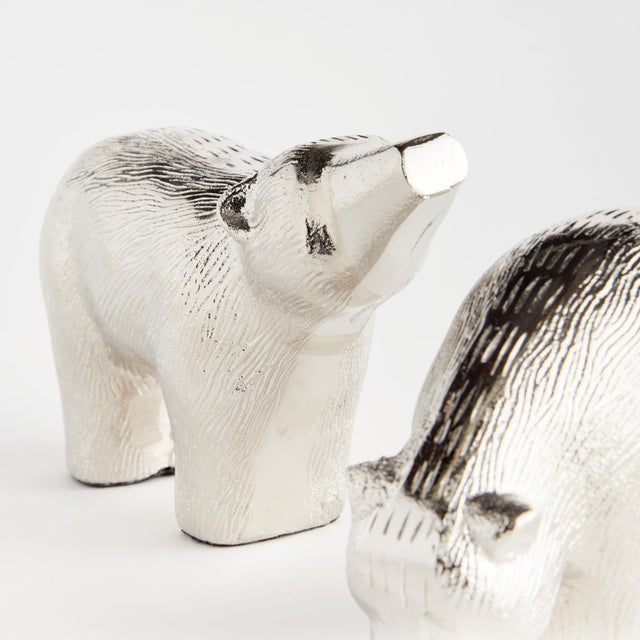 The little one explores, as the momma looks on, these modern polar bear sculptures really bring the charm. Sandcasted by...