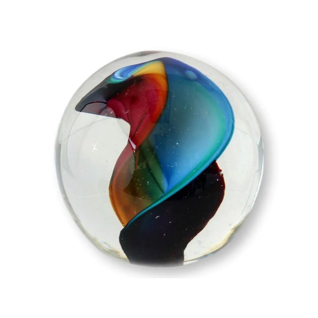 Showcasing a vibrant swirl of colors encased in clear glass, this piece is a testament to the unparalleled artistry of...