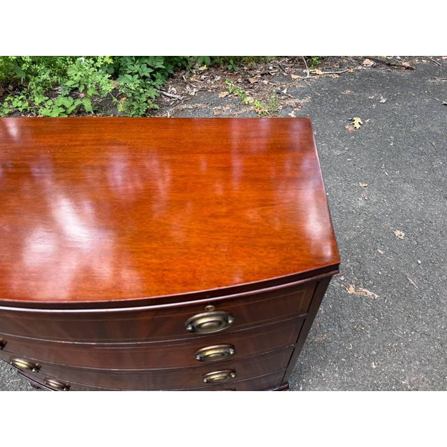 Georgian-style bowfront flame mahogany chest of drawers by Baker Furniture. It features curved front, decorative wood...