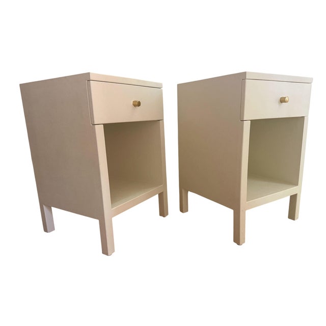 Pair of "Maris" nighstands. Belgian linen wrapped off white with top drawer and brass pull. By Made Goods. From a designer...