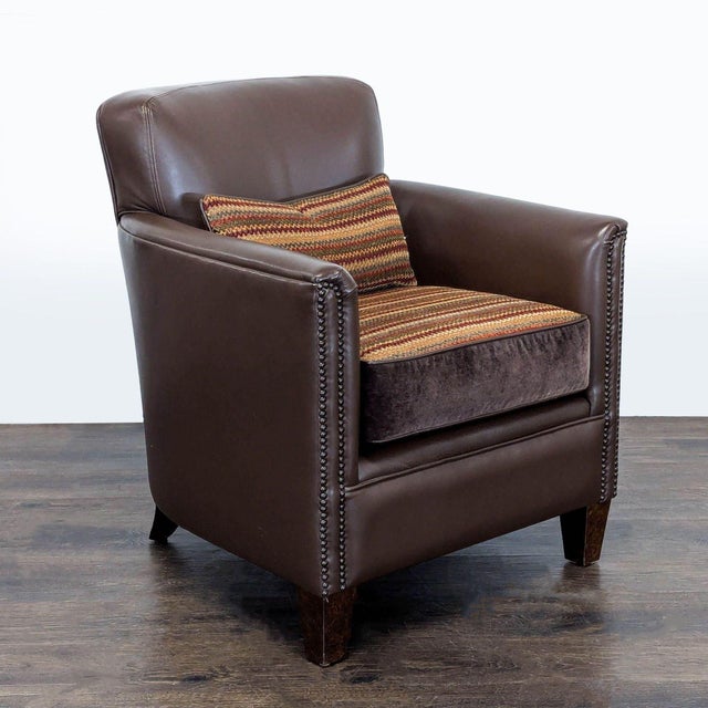 This comfortable lounge chair features a rich brown leather exterior with durable wooden legs. The chair comes with a...