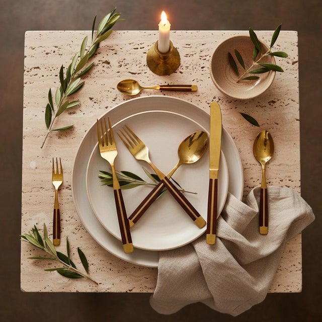 Sophisticated 1960s mid century modern 100-piece flatware set attributed to Jean Claude, crafted in Thailand with warm...