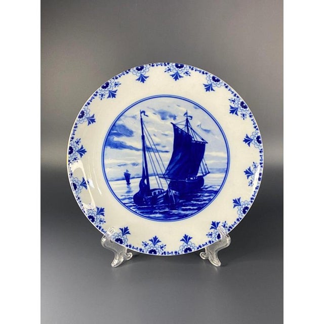 Vintage cobalt blue decorative porcelain plates. On them you can see Dutch sailboats and windmill decoration. They have a...