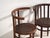 A set of two antique armchairs in bentwood, with a horseshoe back wrapping into the arms, over vertical splats and a...