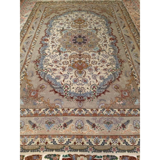 "Discover a true masterpiece of Persian artistry with this magnificent Persian Tabriz room-size rug. A testament to the...