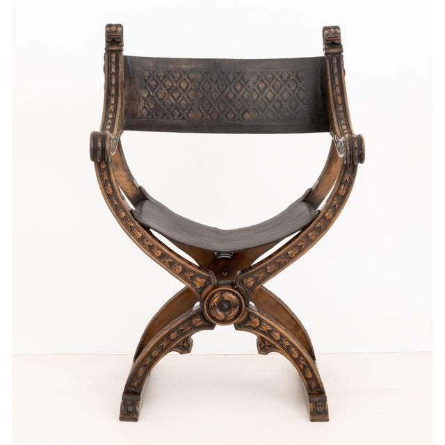 Renaissance Revival Walnut Savonarola Chair, carved foliate pattern frame and leather sling seat on X-form base with...