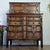 Striking vintage tallboy dresser with three hidden top drawers. This piece is unique in that it has several stunning...