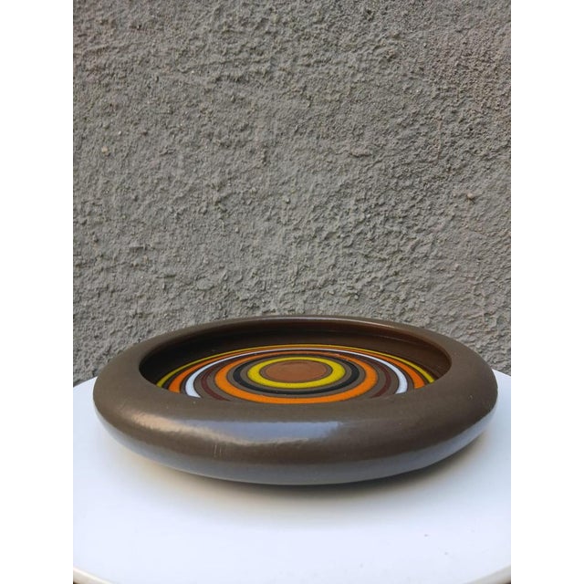 Charming ceramic plate/ashtray from the 1970s with an Op-Art decoration of concentric circles in shades of brown, orange,...